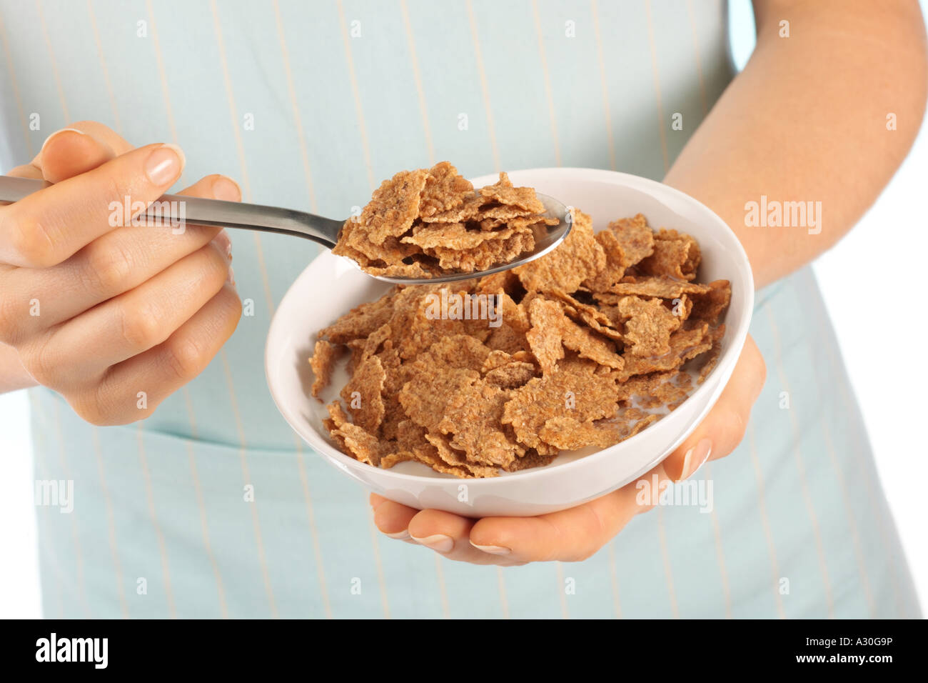 Woman eating all bran breakfast cereal hires stock photography and