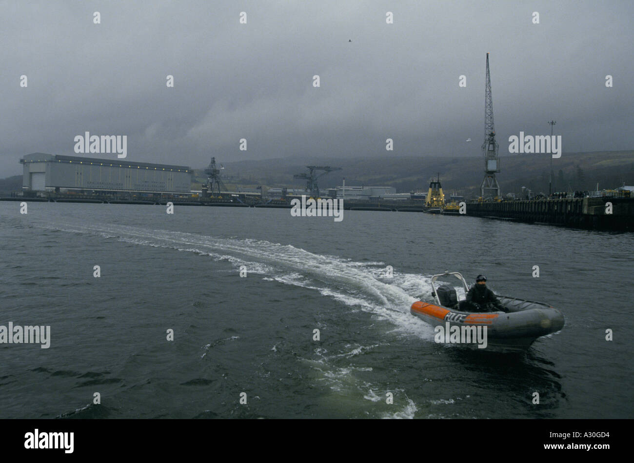 police raft on water at faslane navel base home to trident nuclear armed submarines river clyde Stock Photo