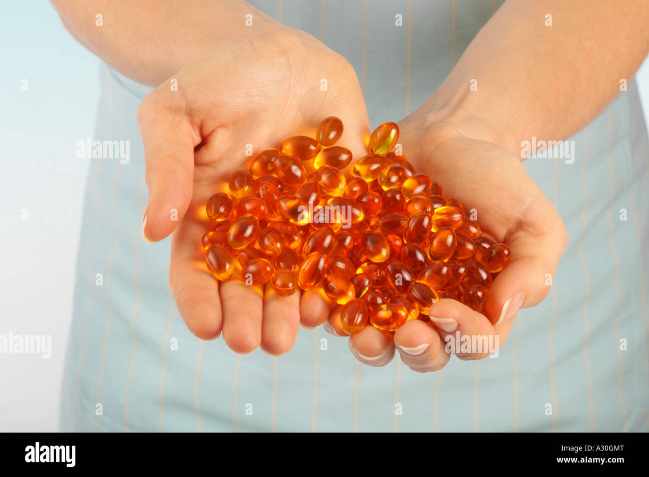 HANDFUL OF VITAMIN OIL CAPSULES Stock Photo