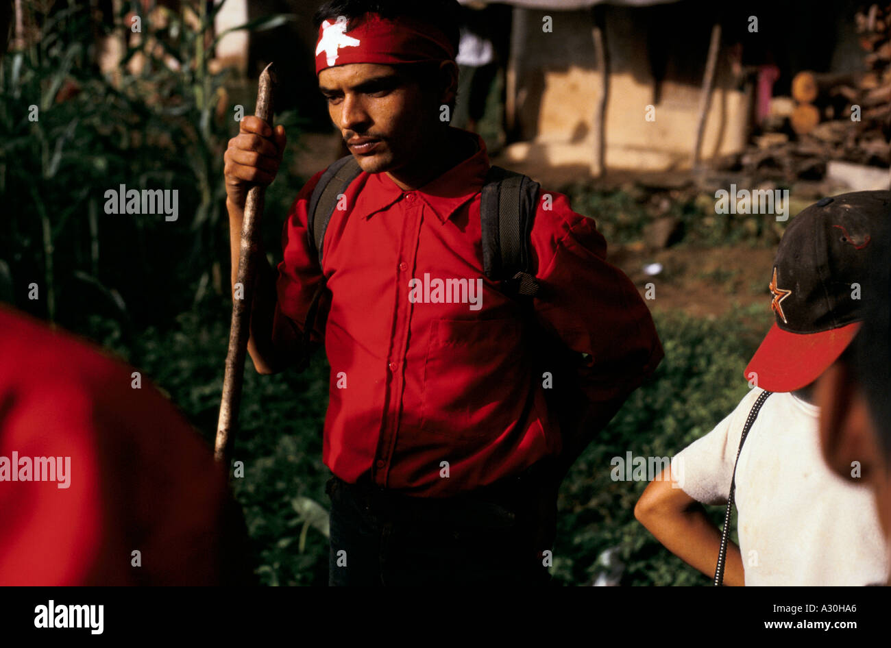 A Maoist rebel cadre with a red shirt and bandana waits to rally in Sailunswor village Dolakha region Nepal Stock Photo