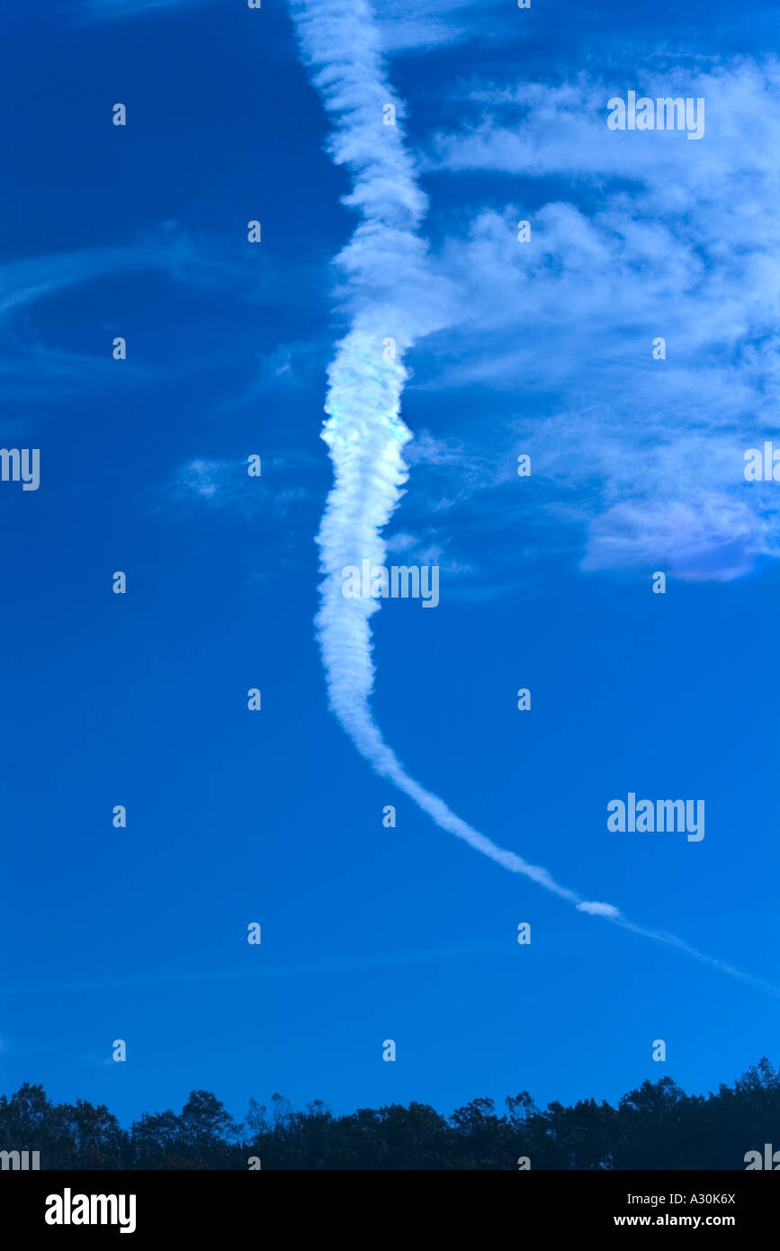 Developing cloud from fading jet airplane contrail Stock Photo