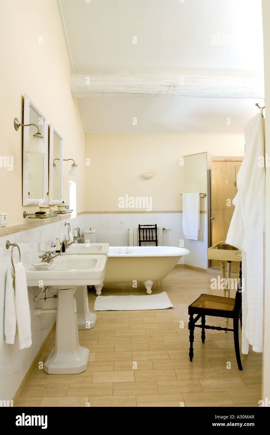 Double washbasins in bathroom with tiled floor Stock Photo