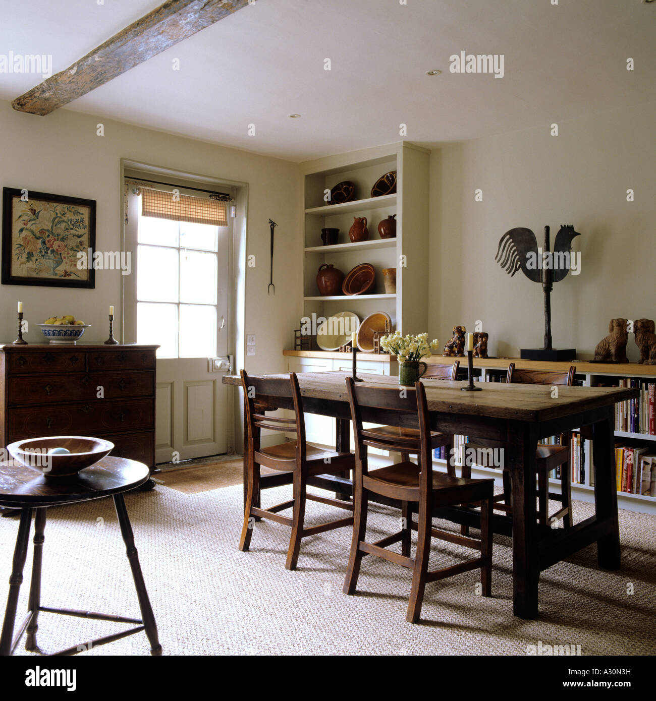Wooden dining room table and beamed ceiling Stock Photo