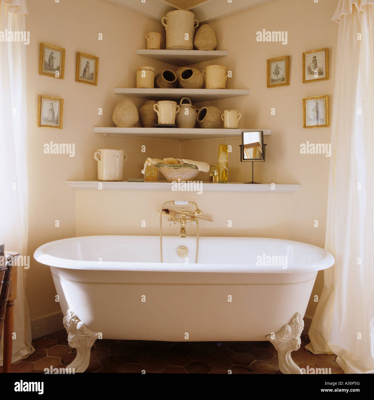 Freestanding bath and shelving with pots Stock Photo