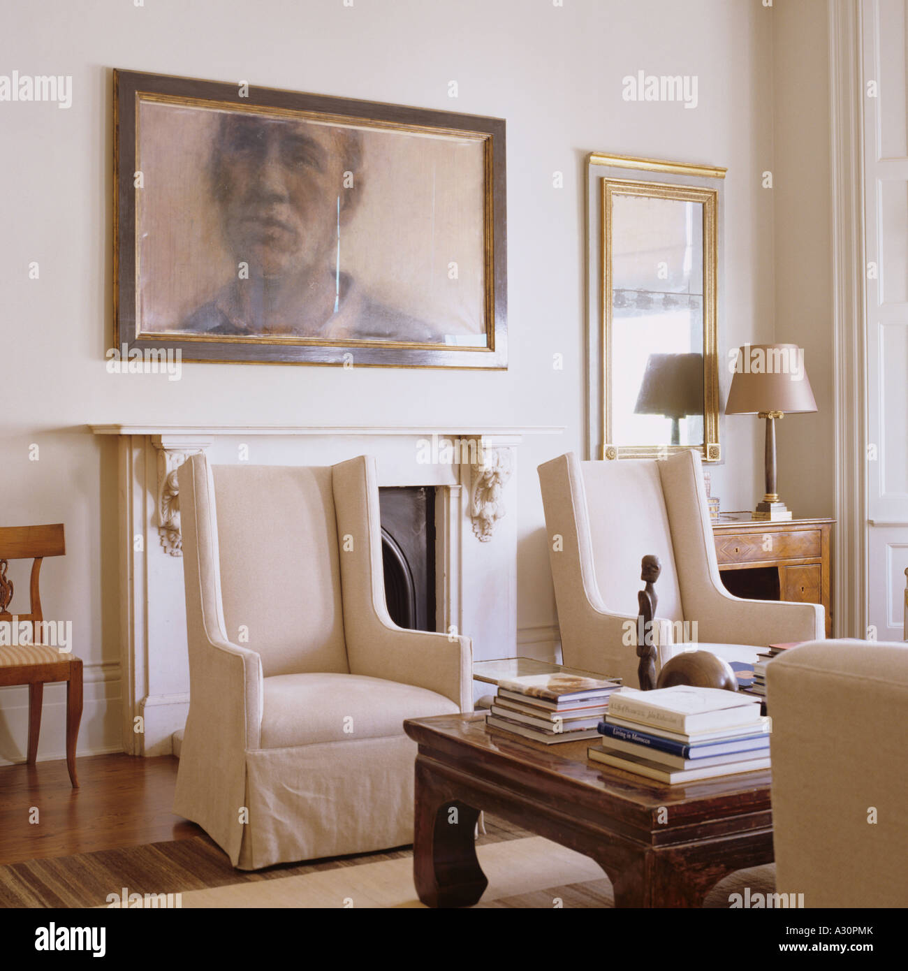 Matching armchairs in living room with artwork Stock Photo Alamy