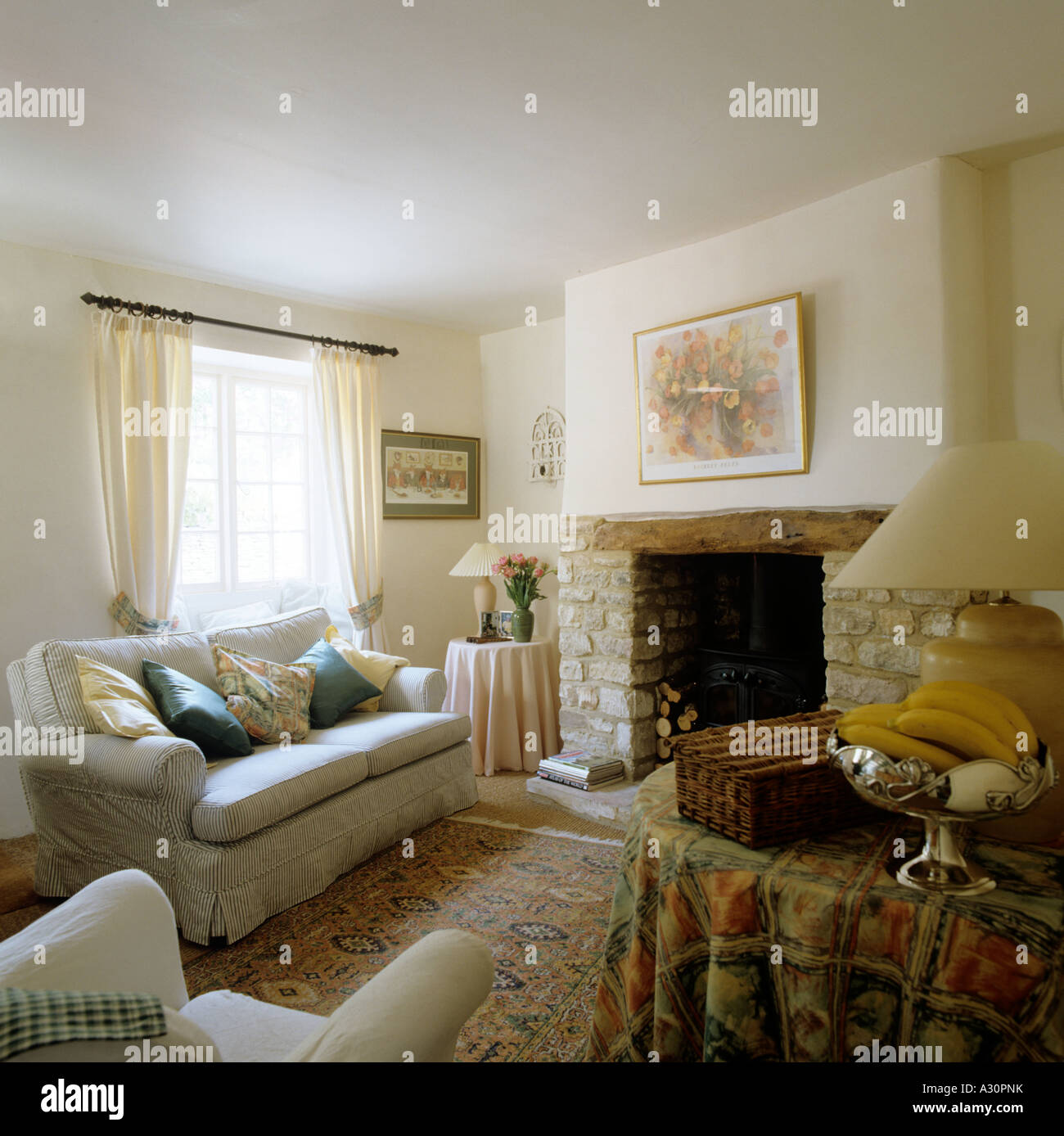 Cottage Living Room With Exposed Stone Fireplace Stock Photo