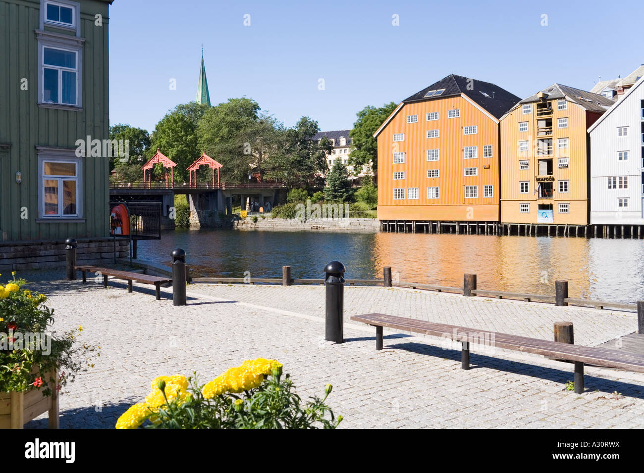 Image showcasing Wooden buildings on stilts along the Nidelva riverfront at Trondheim ...