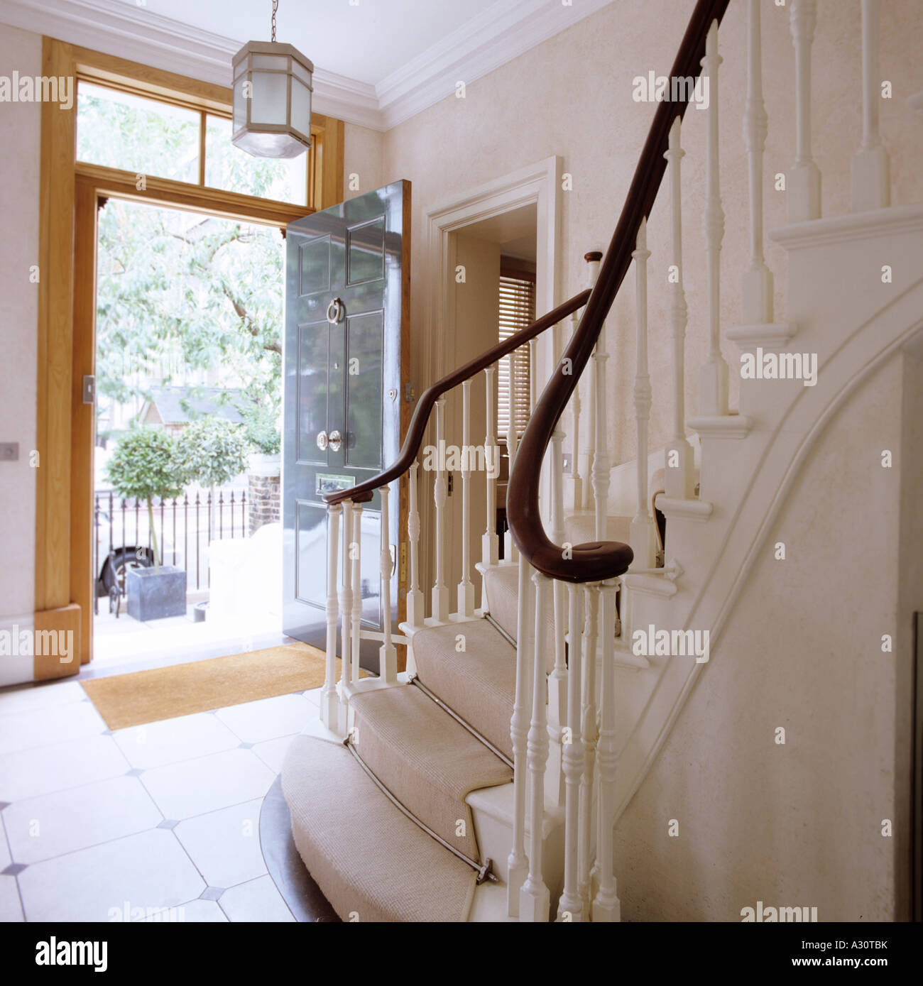entrance hall with open door and stairs of a Victorian London townhouse Stock Photo