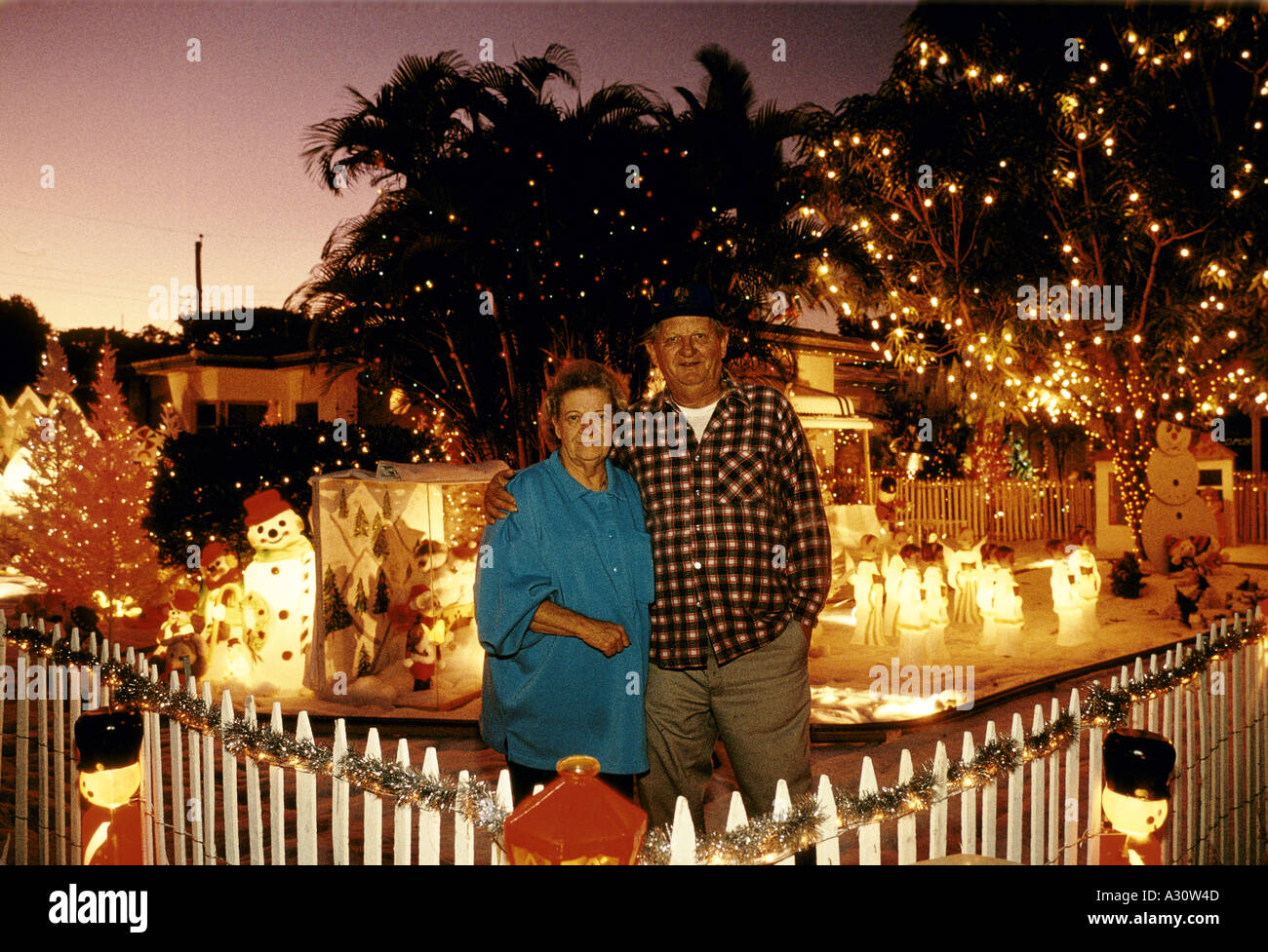 christmas decorations florida a couple outside their decorated house south miami Stock Photo