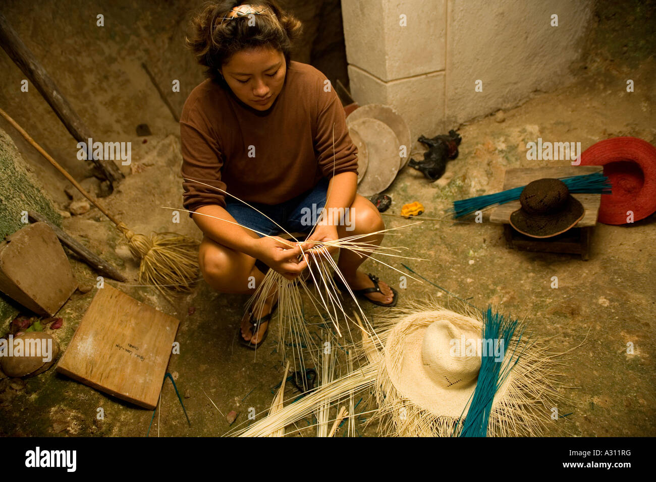 Woman braiding the famous panama straw hats in a traditional cave in ...