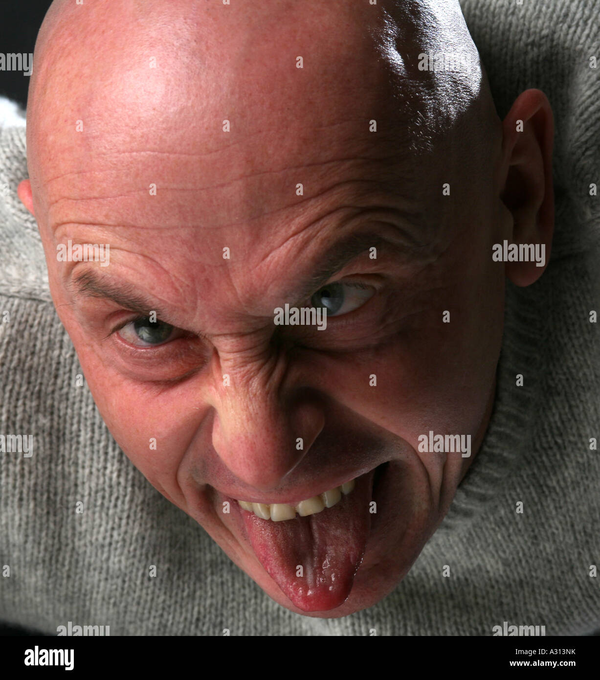 Studio shoot of angry bald man Stock Photo - Alamy