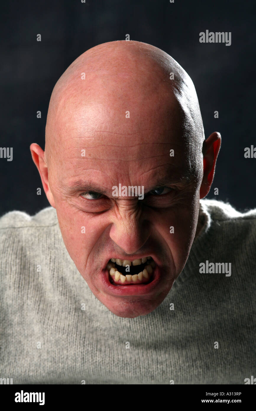 Studio shoot of angry bald man Stock Photo - Alamy