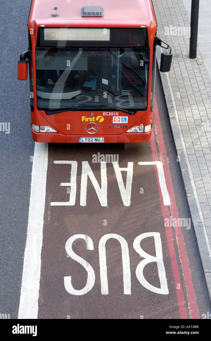 Photograph of London red bus on bus lane showing alternative to driving in the congestion zone by using London red bus Stock Photo