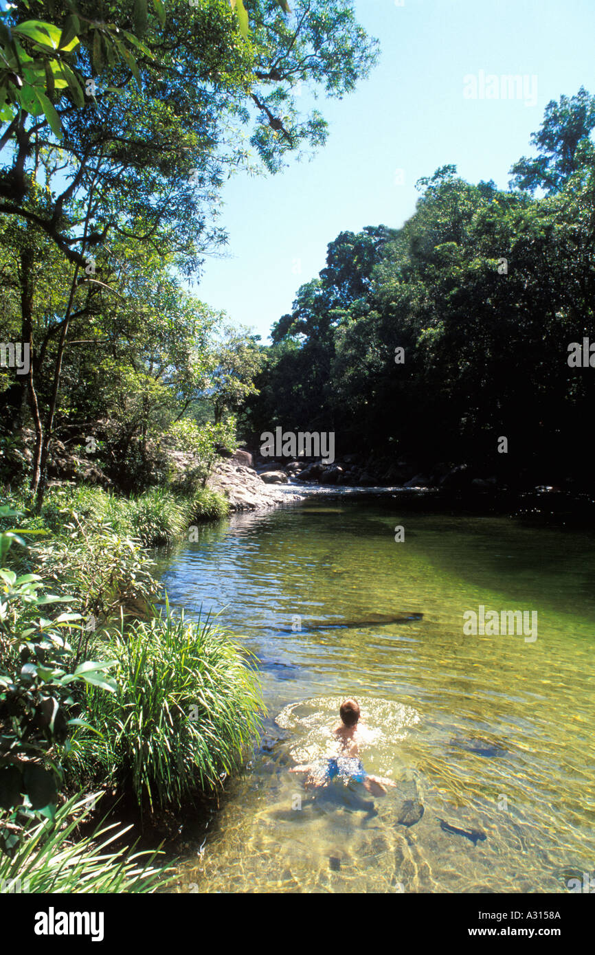 Boy swimming at Mossman Daintree National Park Queensland