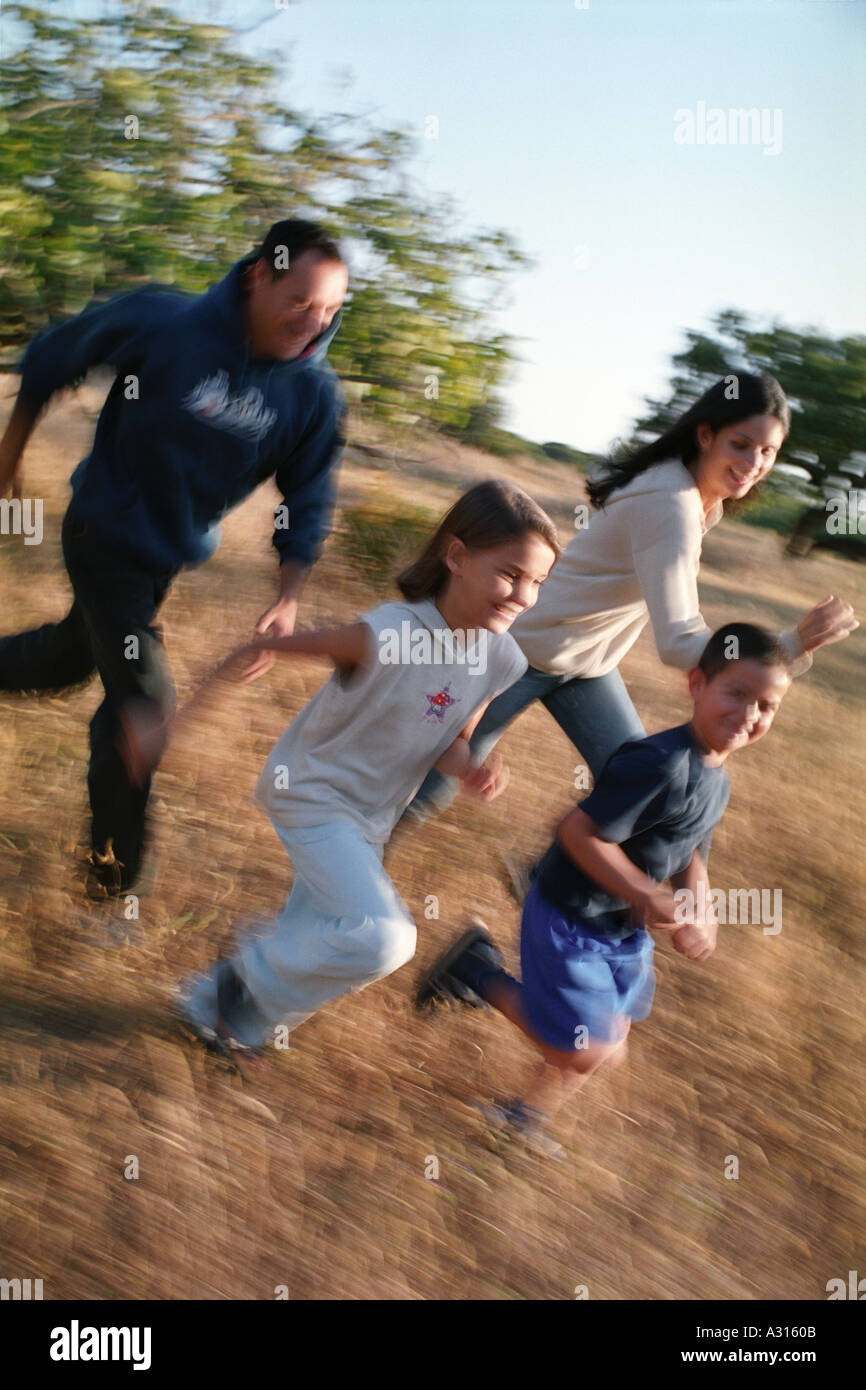 family running through meadow Stock Photo - Alamy