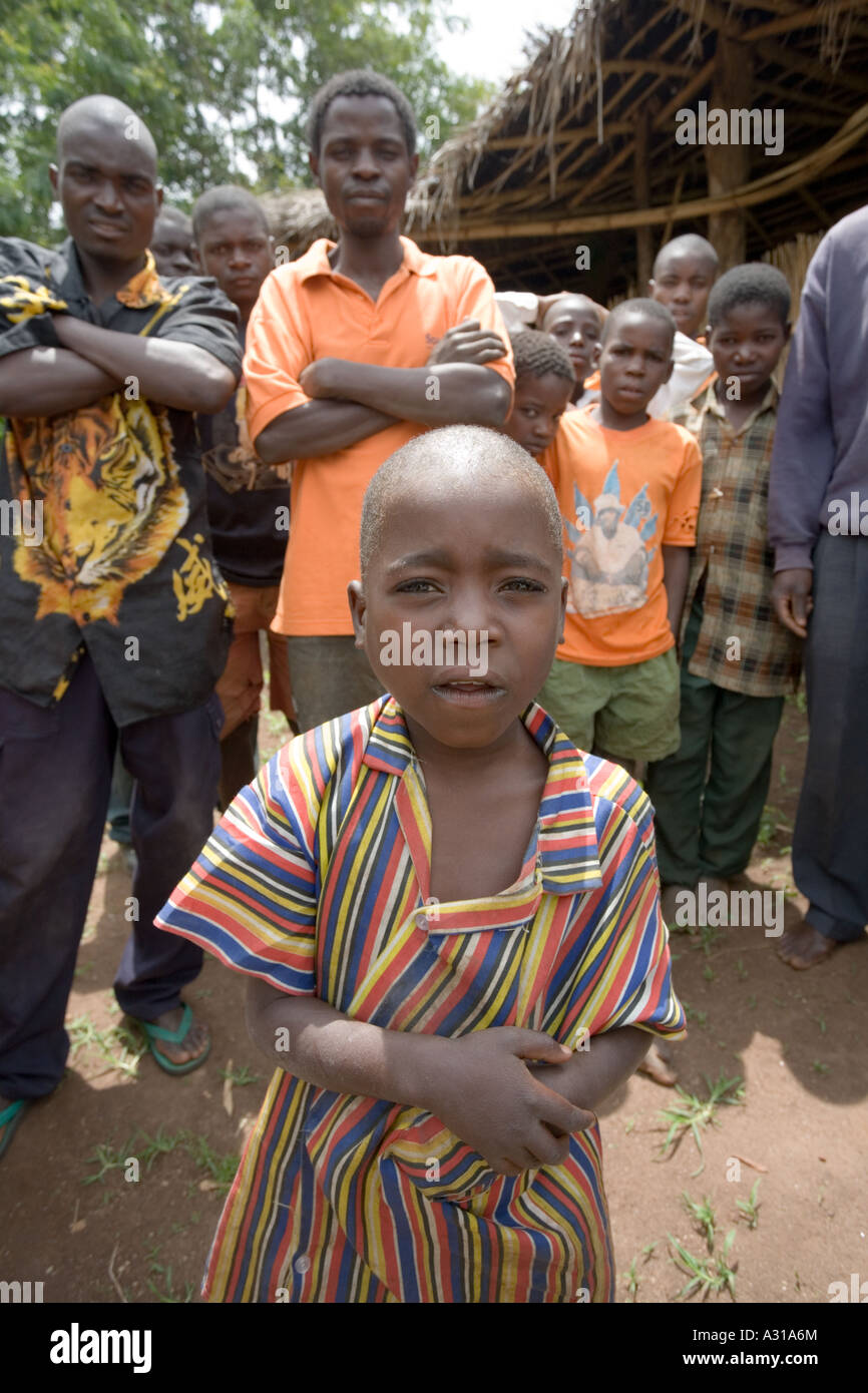7 year old orphan attending the Sunday morning service at the grass hut church in the village of Mombala (Mambala) Malawi Africa Stock Photo
