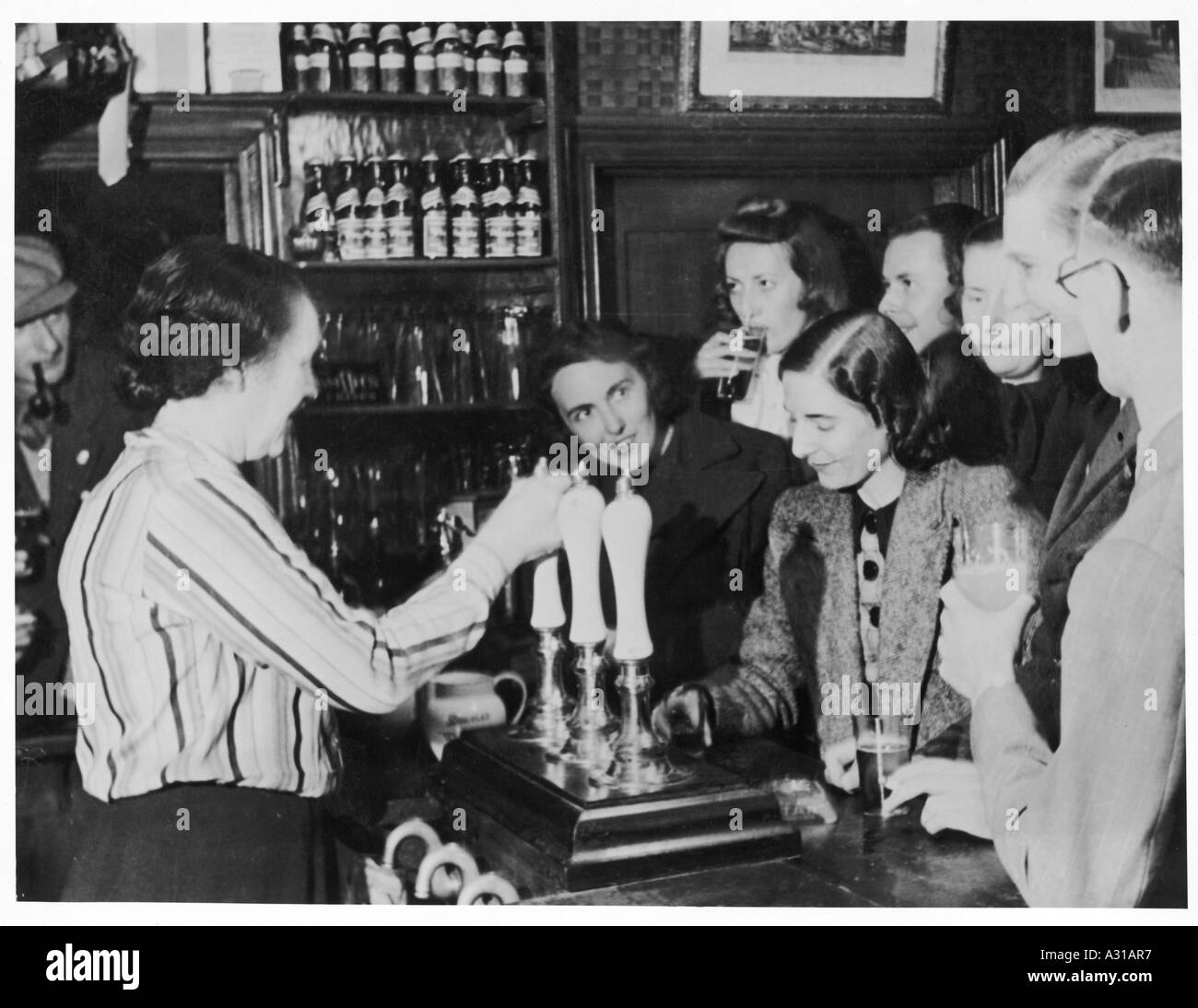 Barmaid Happy Drinkers Stock Photo - Alamy
