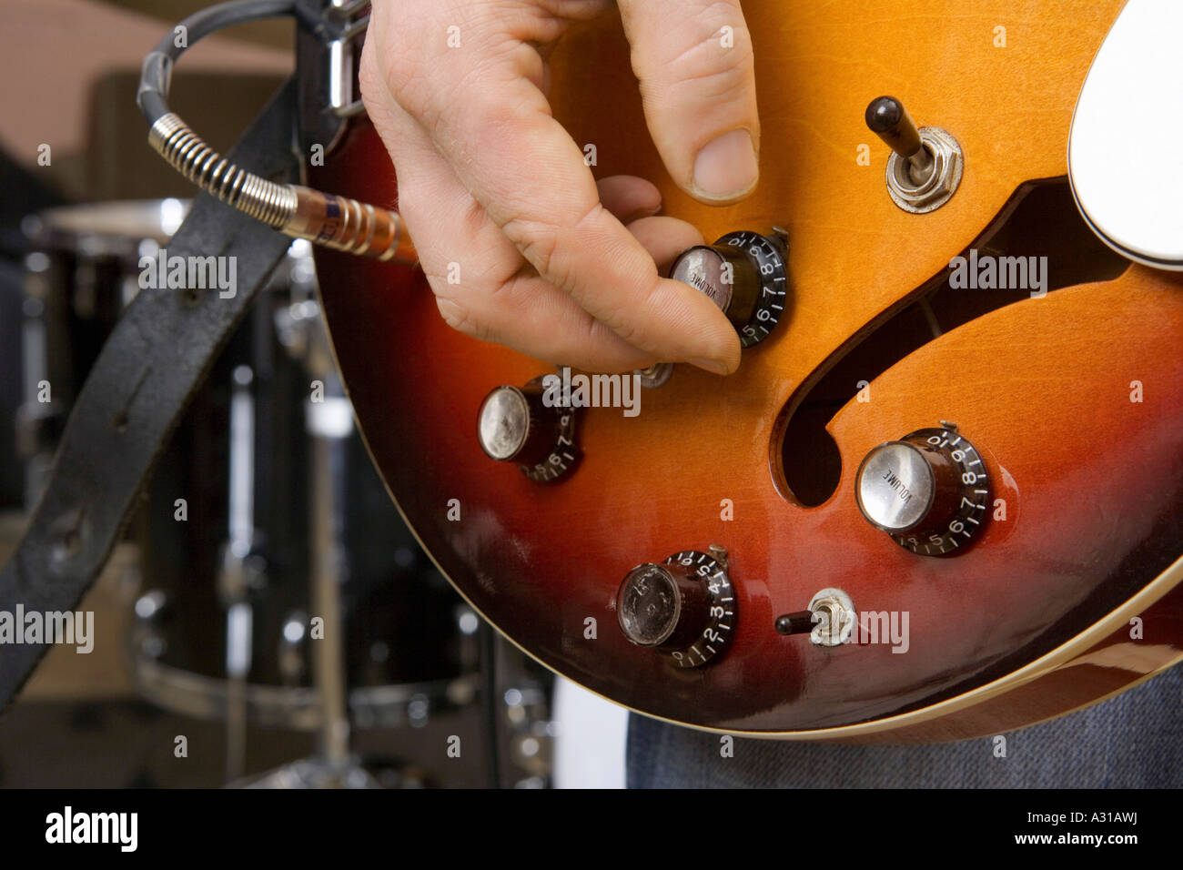Close up of guitarist tuning guitar Stock Photo