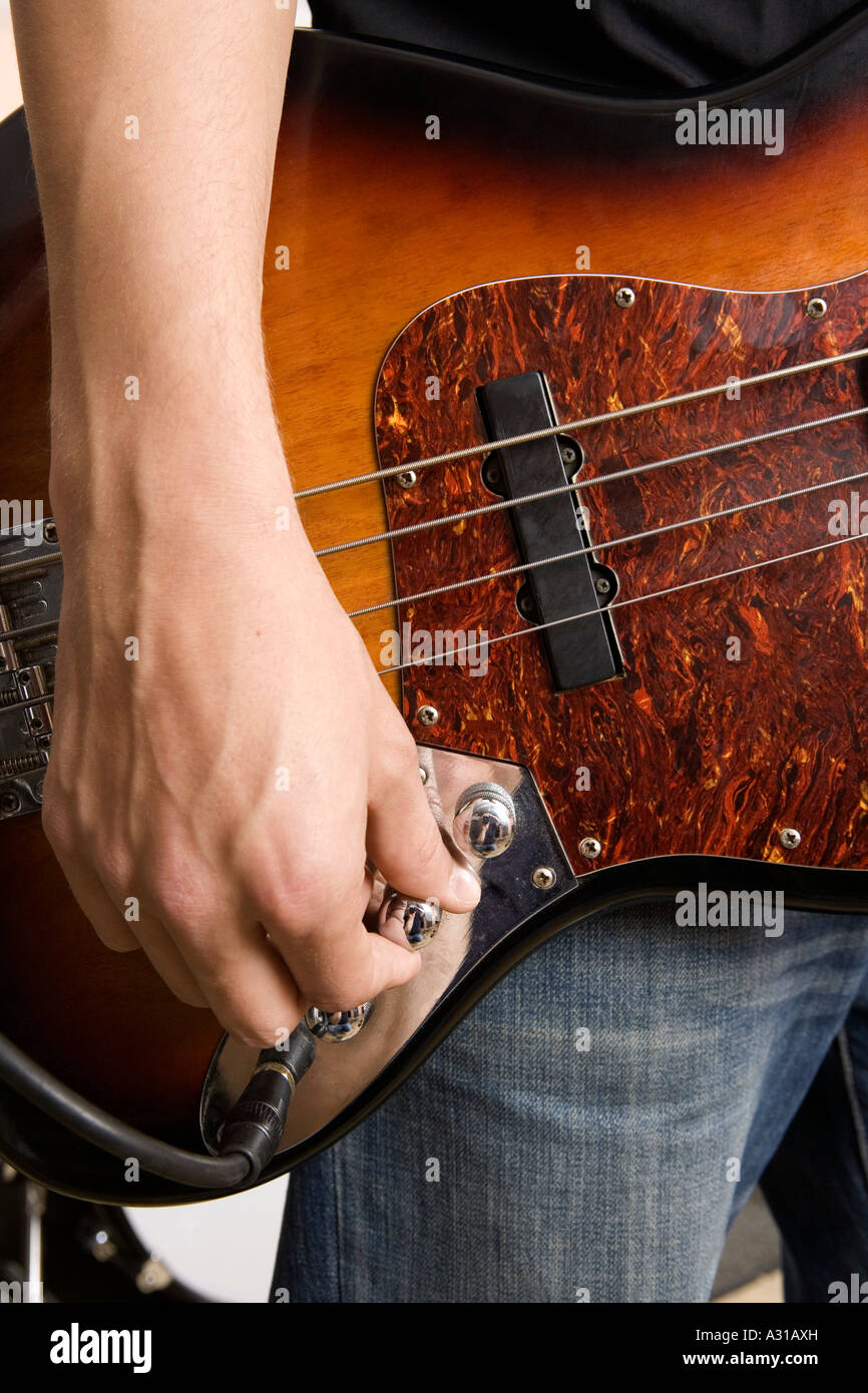Guitarist tuning guitar Stock Photo