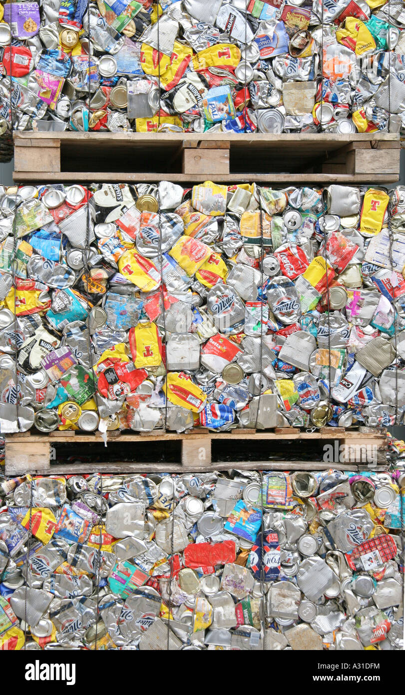 Stacked pallets of crushed cans in refuse recycling depot Stock Photo