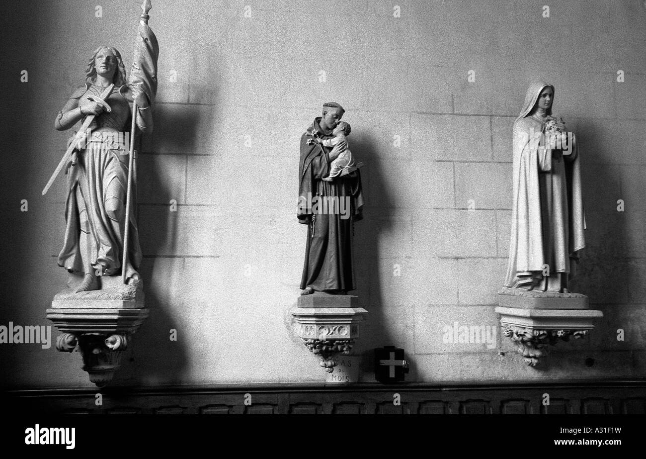 three statues of saints on a church wall Stock Photo Alamy