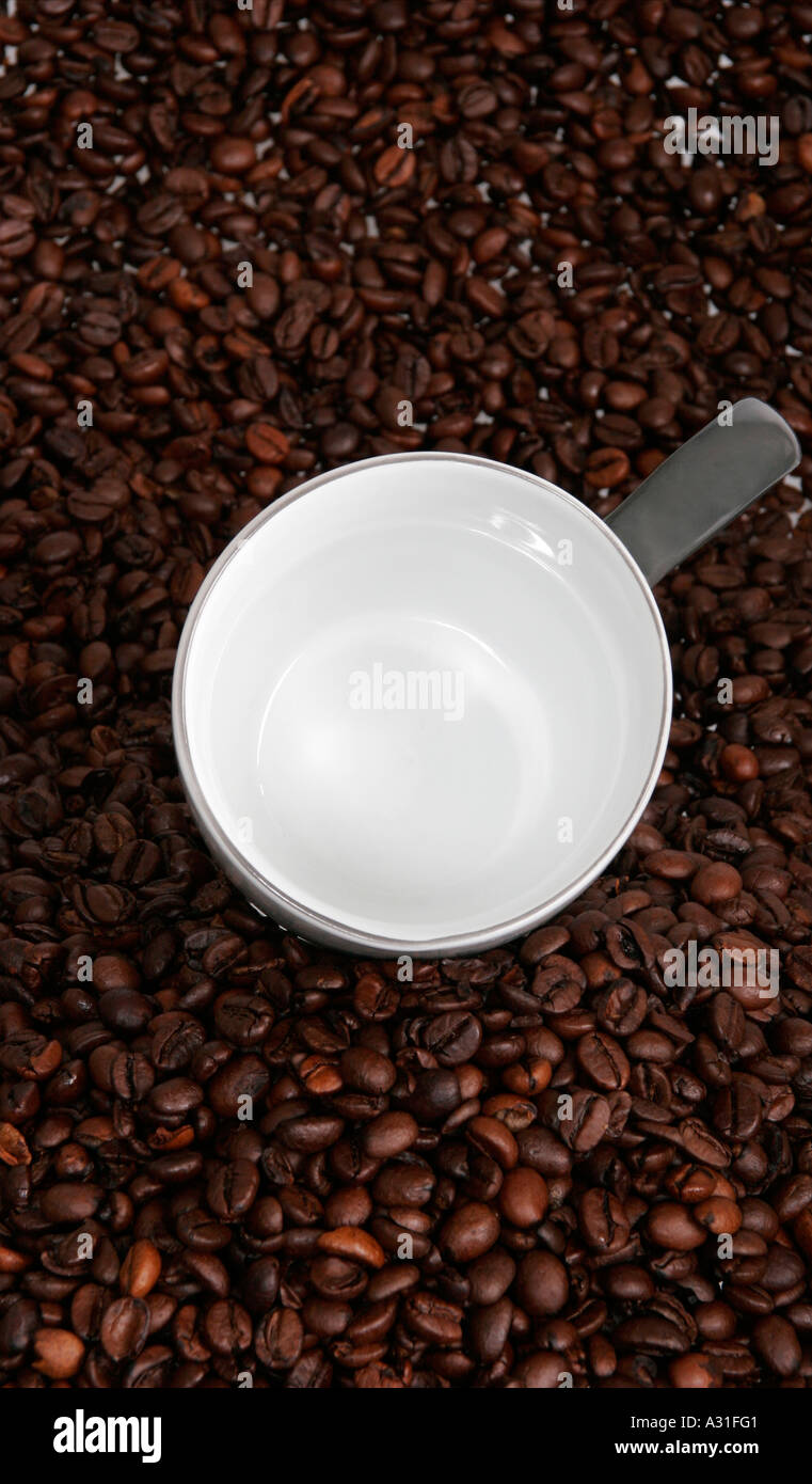 Empty cup on coffee beans elevated view Stock Photo