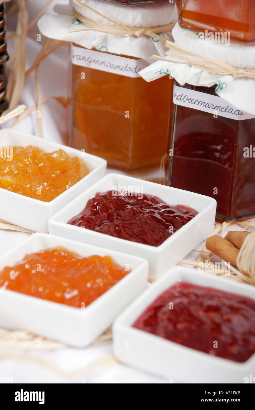 Marmalade in jars and bundle of cinnamon sticks Stock Photo