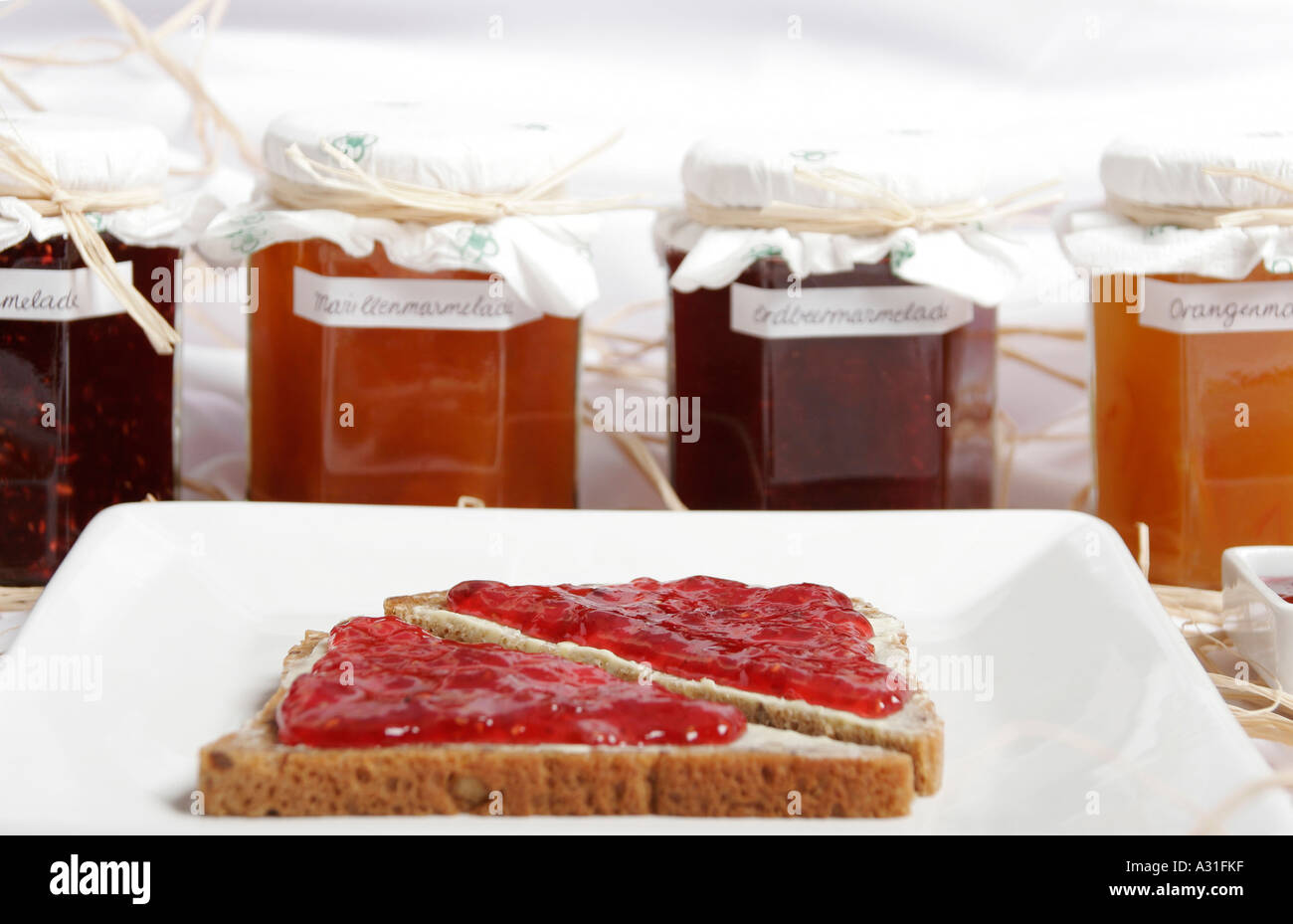 Slice of jam bread and marmalade jars Stock Photo