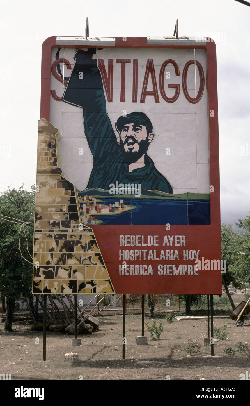 Billboard depicting Fidel Castro holding a machine gun aloft and patriotic words below such as Rebel Always, Santiago, Cuba Stock Photo