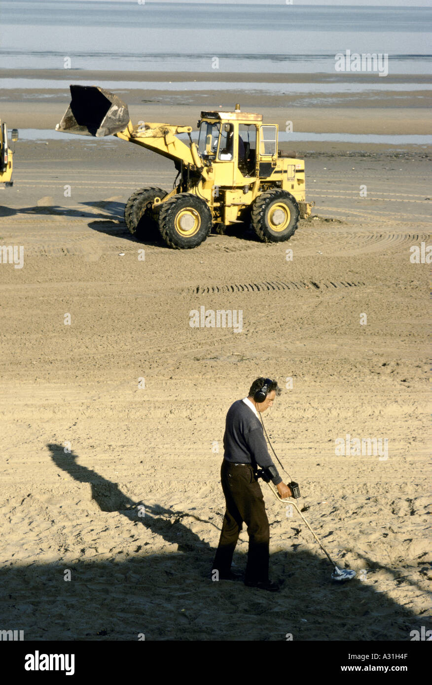 man with metal detector wheel loader on empty blackpool beach 1995
