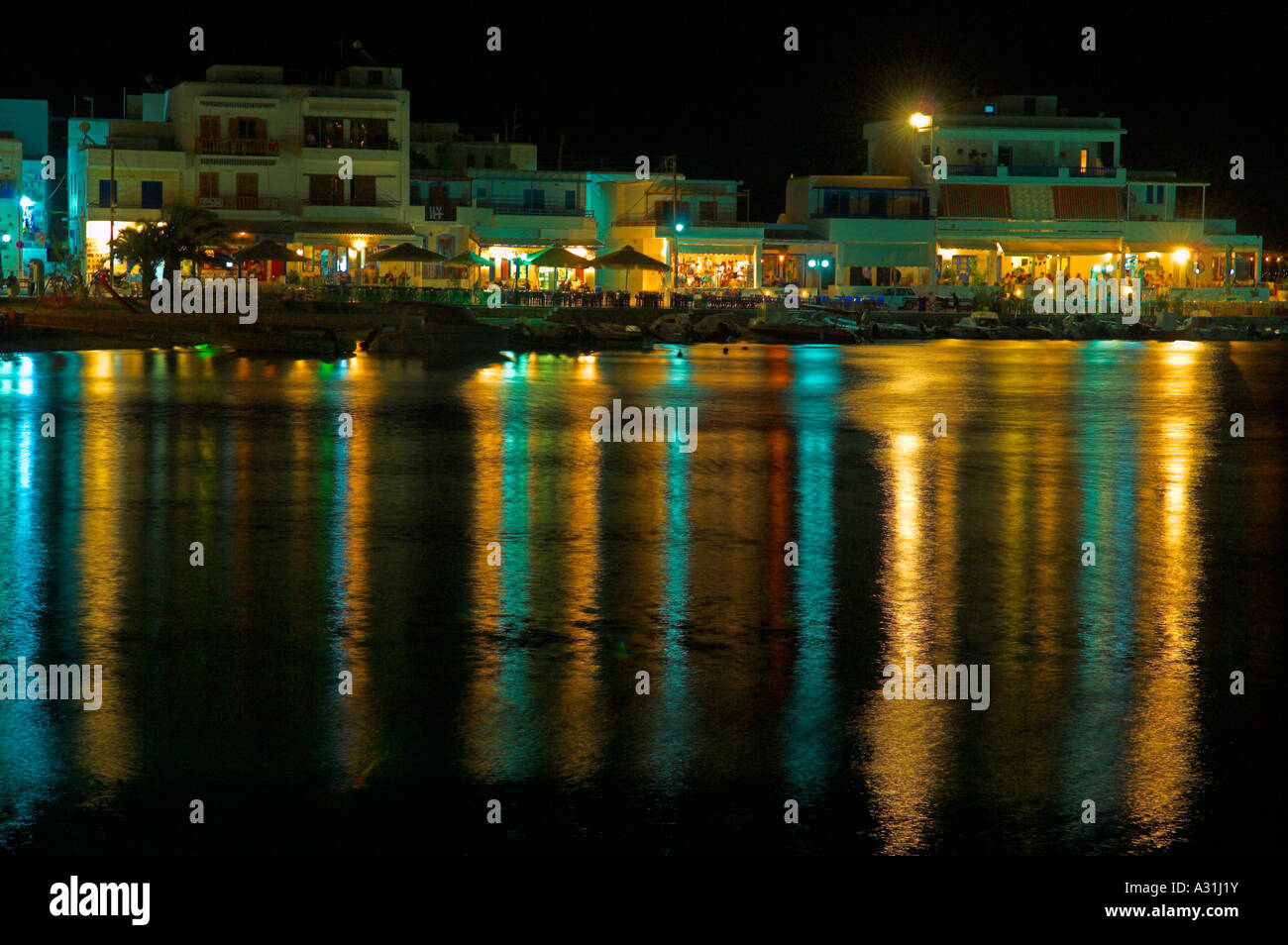 Night life lights reflections in sea of Piso Livadbi on south coast of Paros Island Greece Stock Photo
