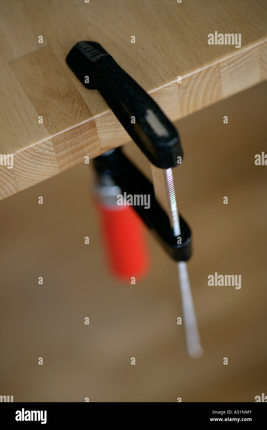 Clamp attached to wooden bench Stock Photo