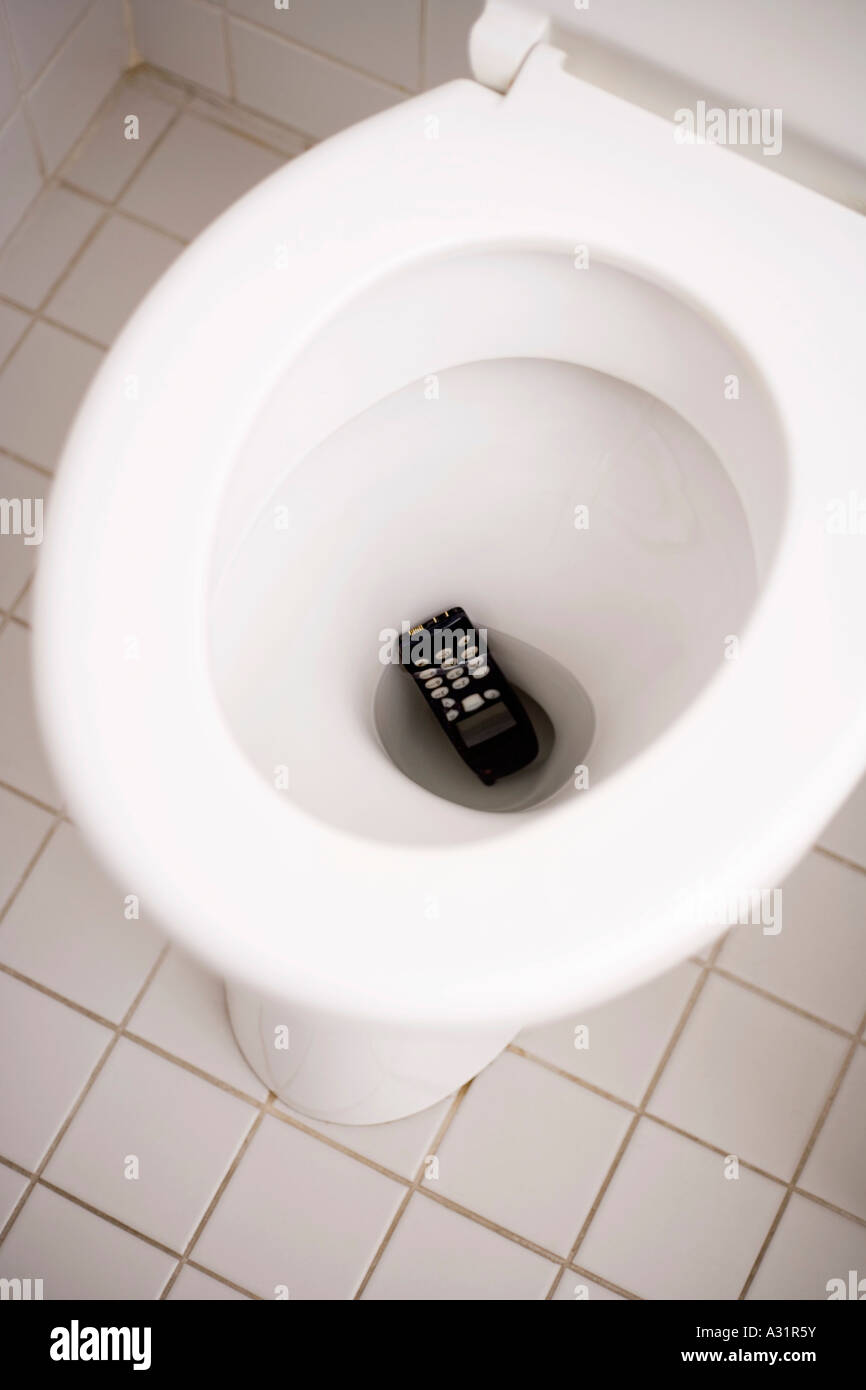 Mobile phone dropped down toilet Stock Photo - Alamy