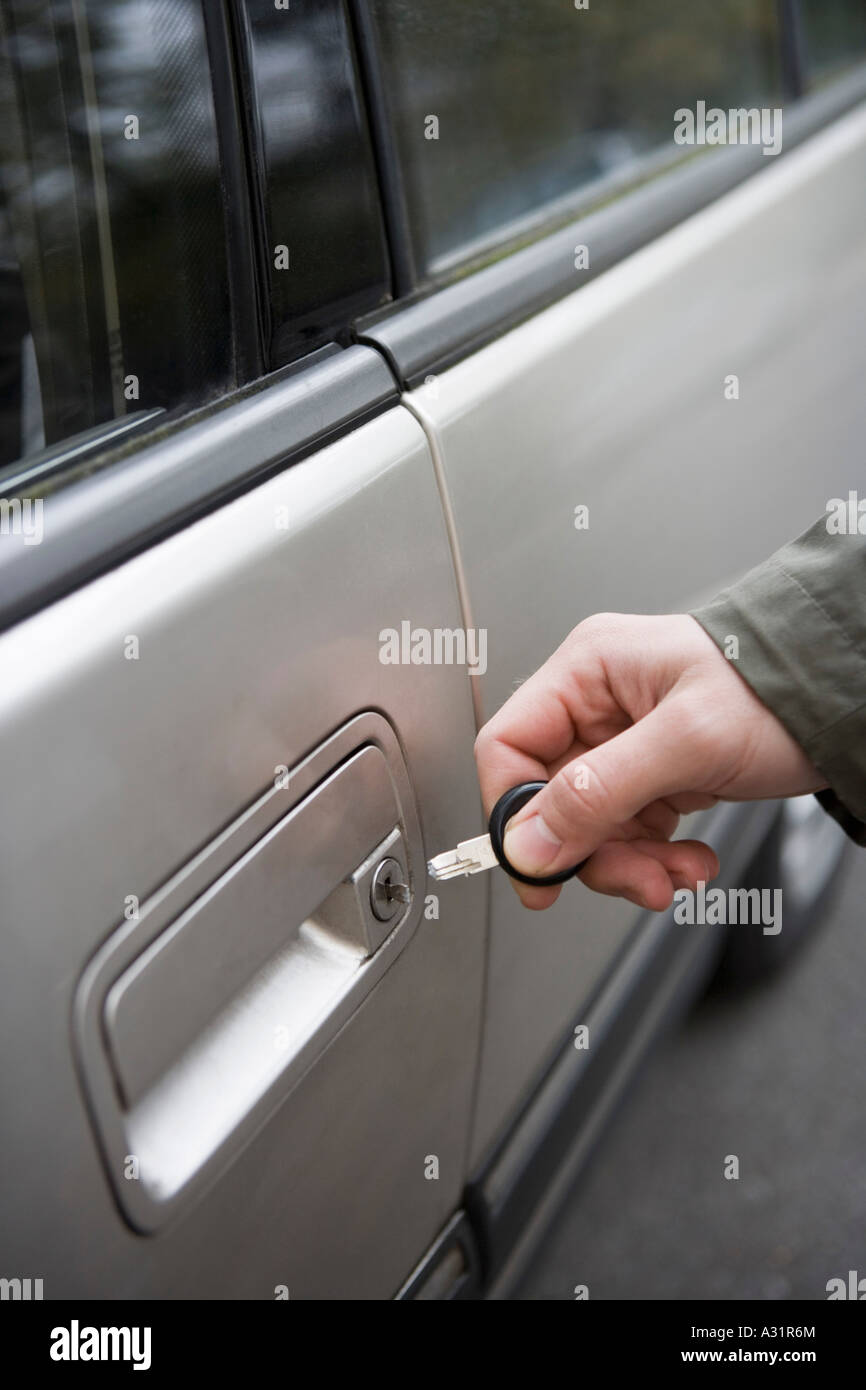 Man Standing Next To Car With Broken Key In Lock Stock Photo