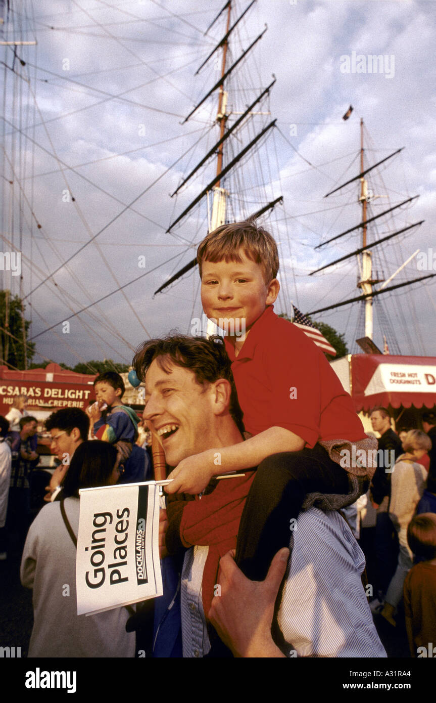 dad carrying child on his shoulders by the cutty sark at greenwich london Stock Photo