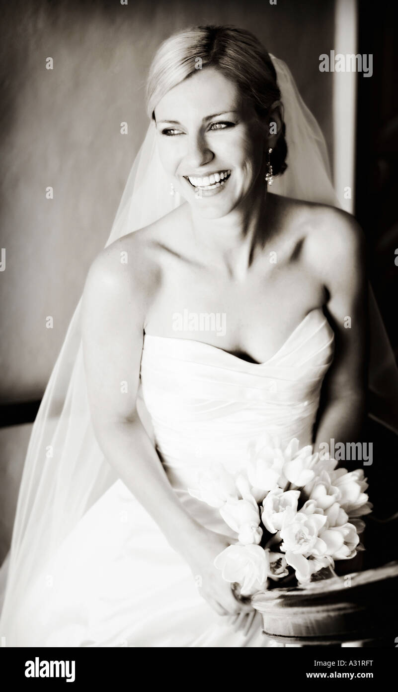 Portrait of bride holding wedding bouquet and looking away Stock Photo ...