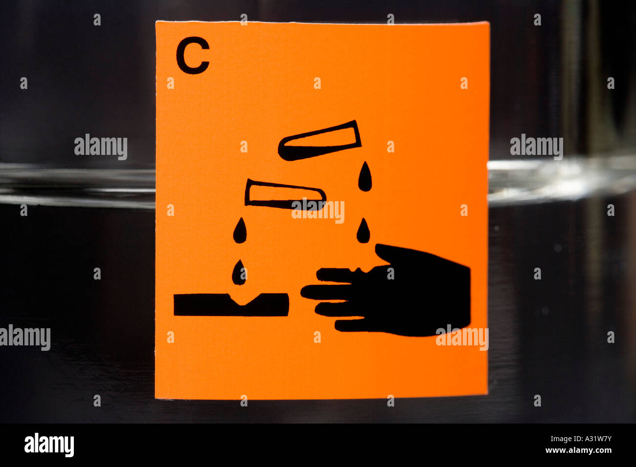 Corrosive label on glass flask containing liquid Stock Photo Alamy