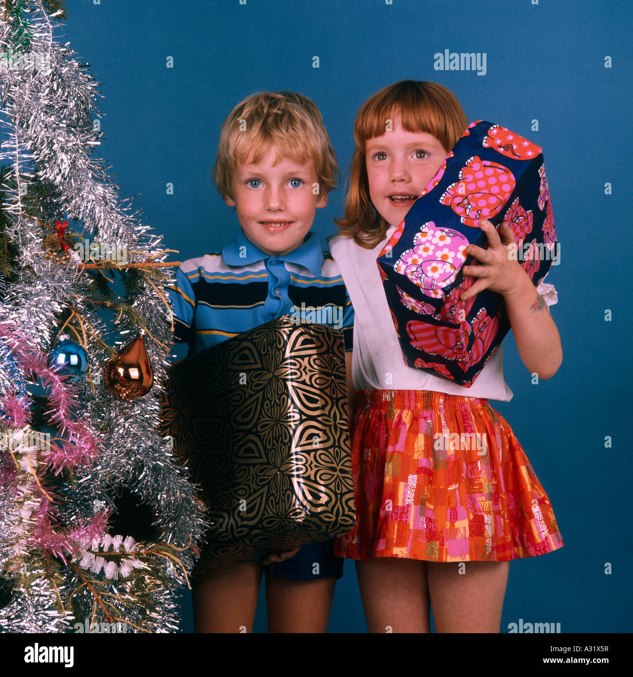 Children with Christmas tree and presents - Retro 1970s - original Stock Photo