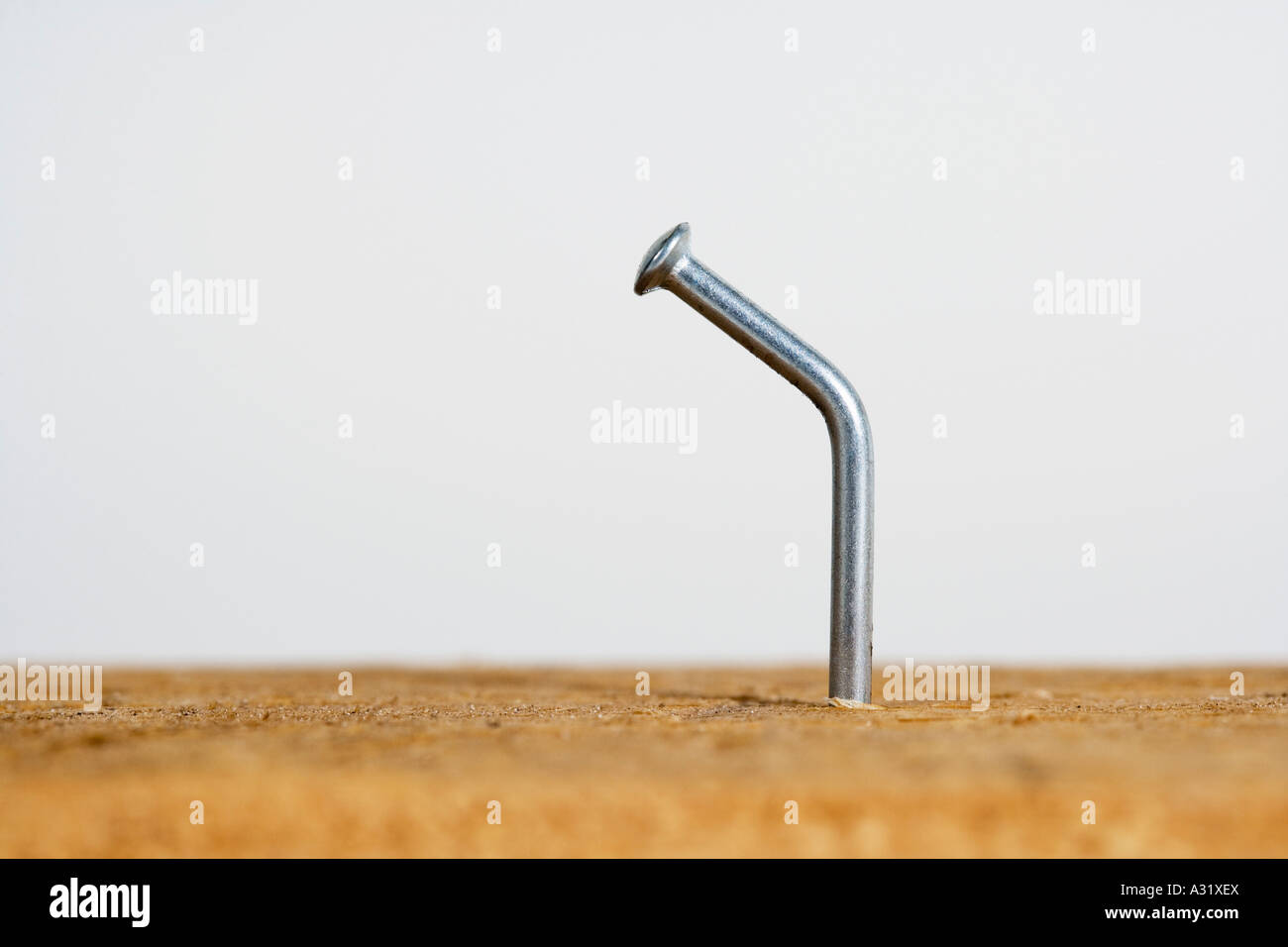 Bent nail in wood Stock Photo - Alamy