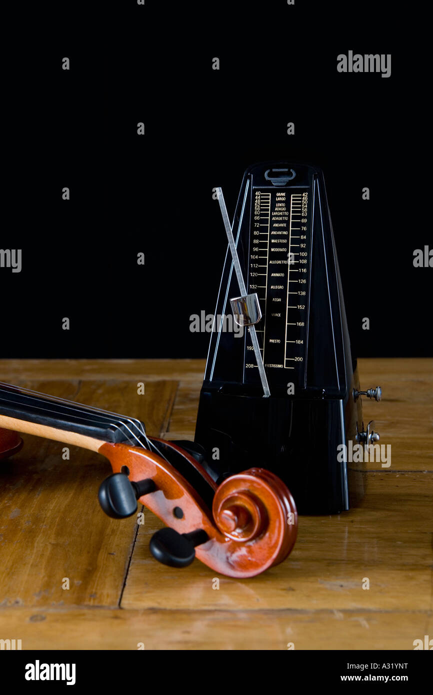 Metronome and violin on wooden table Stock Photo Alamy
