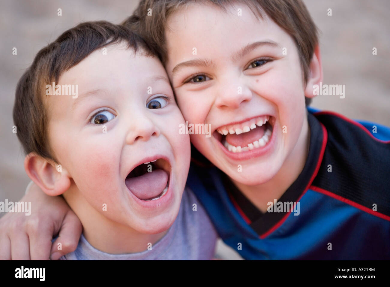 Brothers standing together and laughing Stock Photo