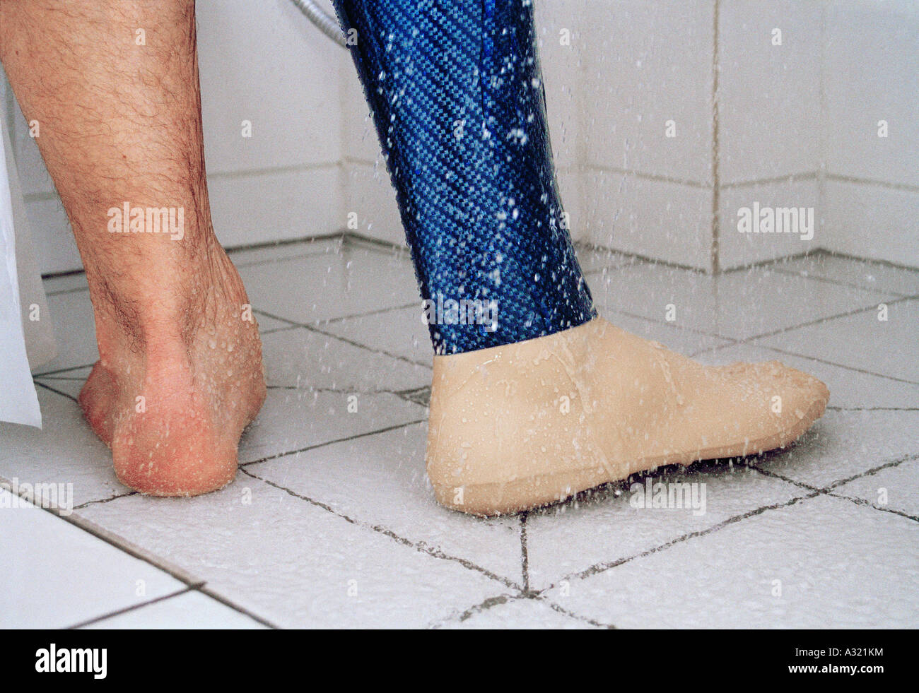 Low section of man showering with prosthetic leg Stock Photo Alamy