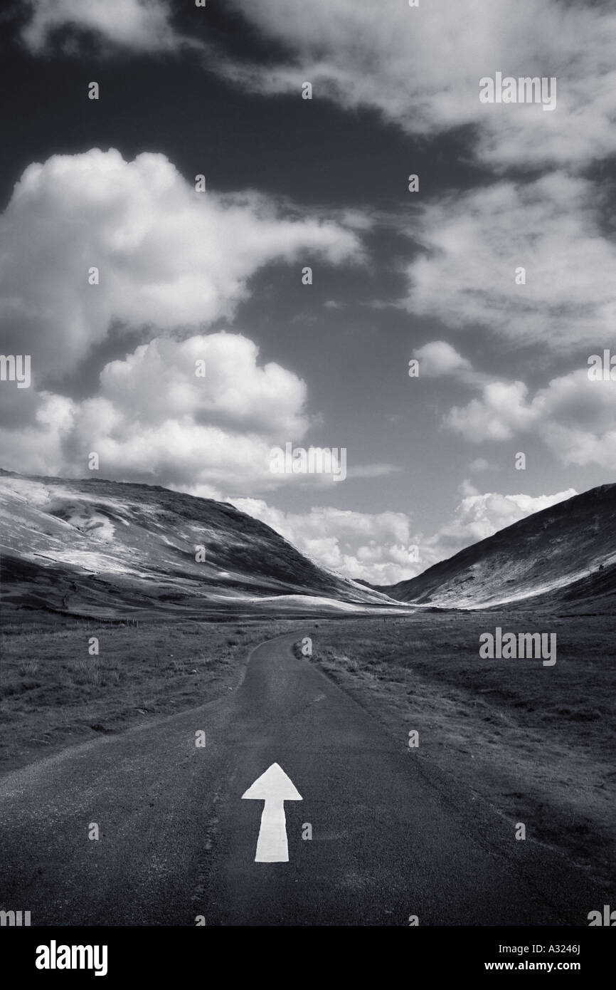 a white arrow on a empty road Stock Photo