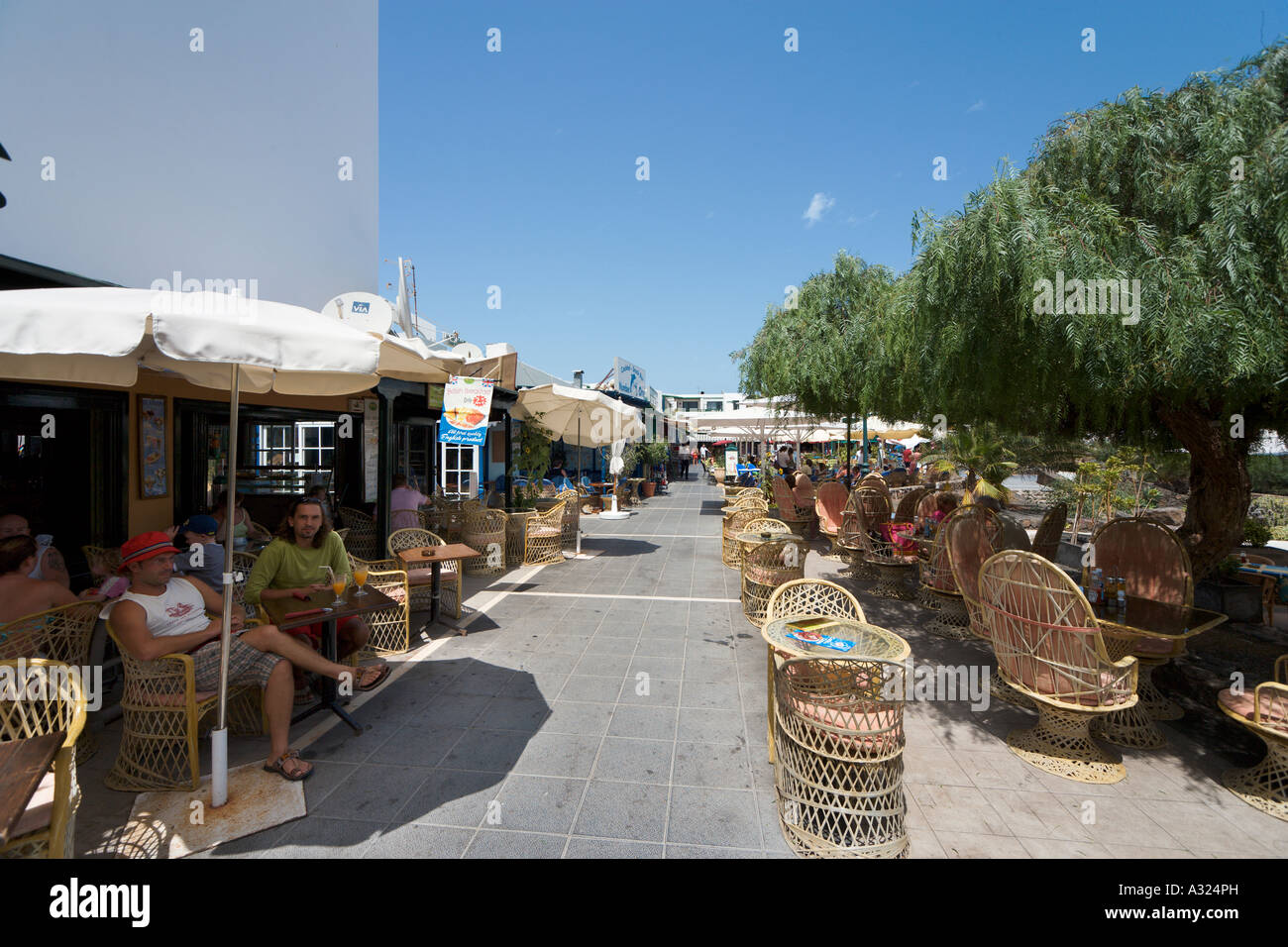 Sidewalk cafe in the shopping centre at Playa de las Cucharas, Costa Teguise, Lanzarote, Canary Islands, Spain Stock Photo