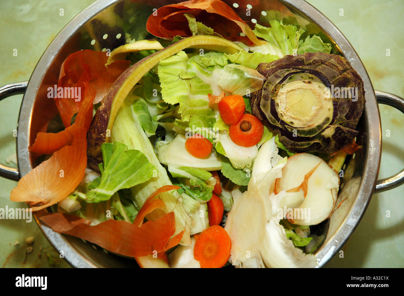 Vegetable peelings saved in a colander before placing in a compost bin