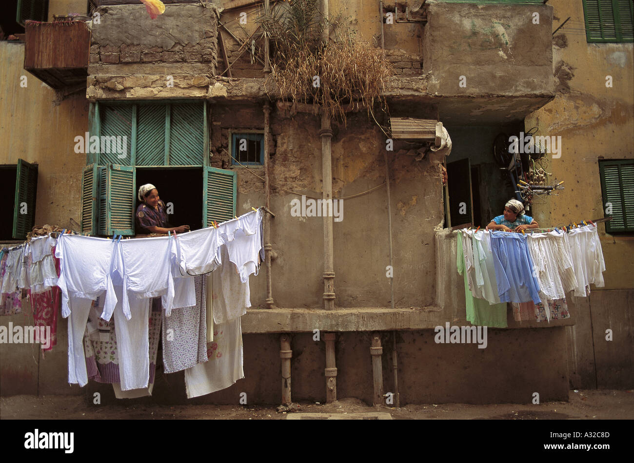 https://c8.alamy.com/comp/A32C8D/wash-day-with-laundry-hanging-outside-a-window-of-a-house-in-old-cairo-A32C8D.jpg