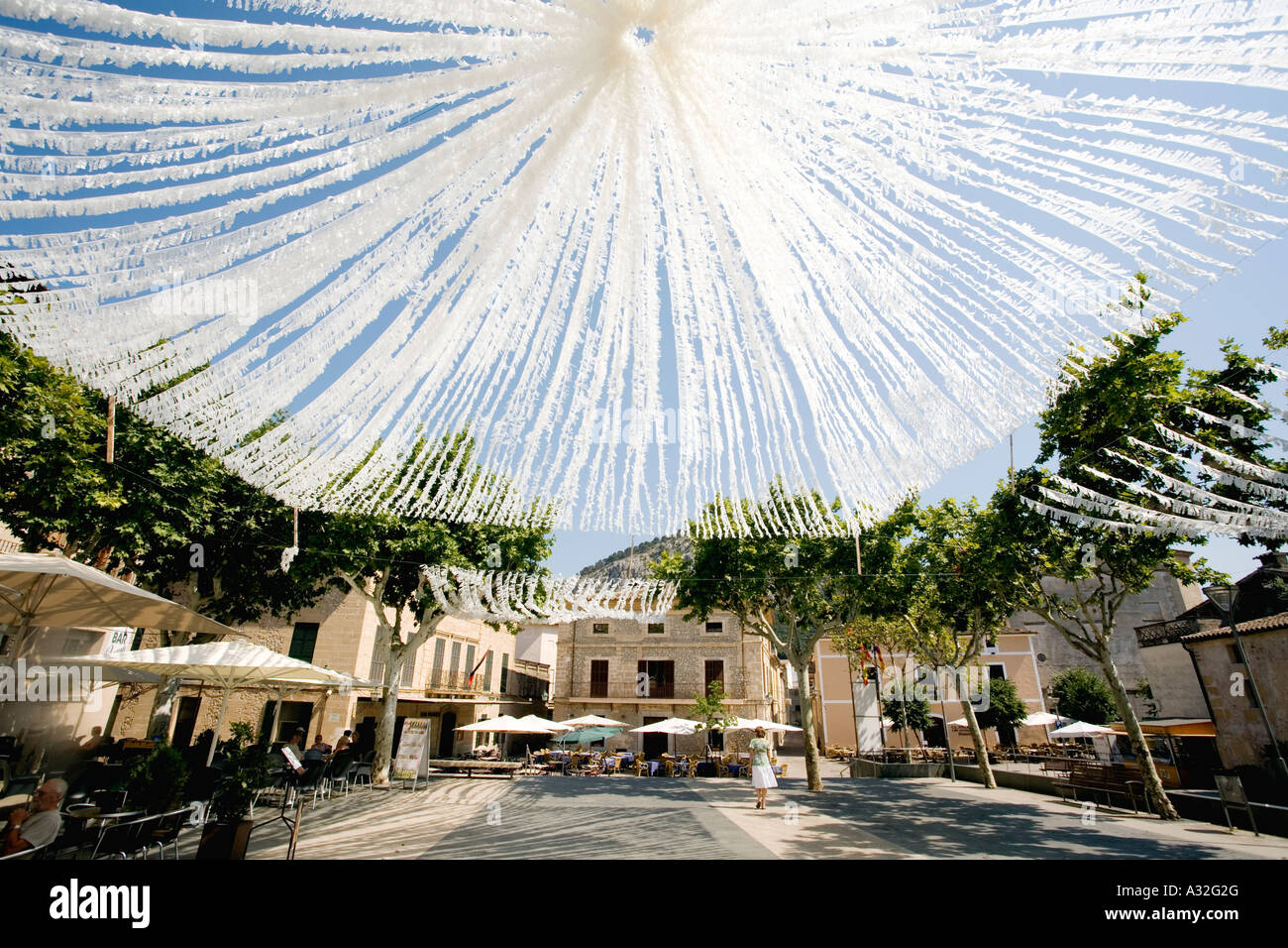 Streamers decorate Placa Major the main square in the town of Pollenca ...