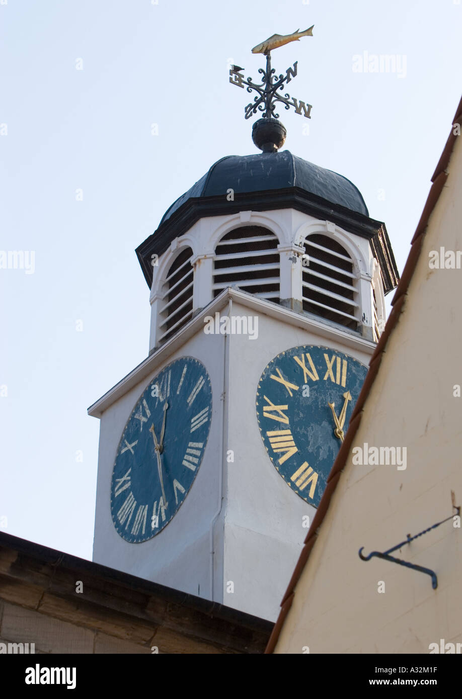 Clock tower with blue clock face and weathervane in Whitby Scarborough north yorkshire england uk Stock Photo