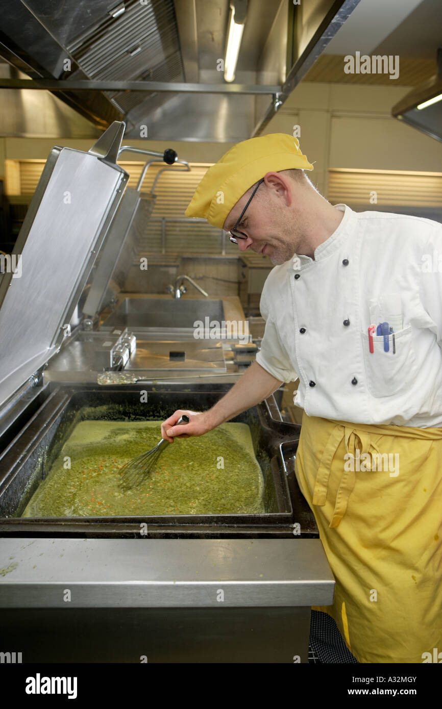 The cook and the chef de cuisine in his canteen kitchen Stock Photo Alamy