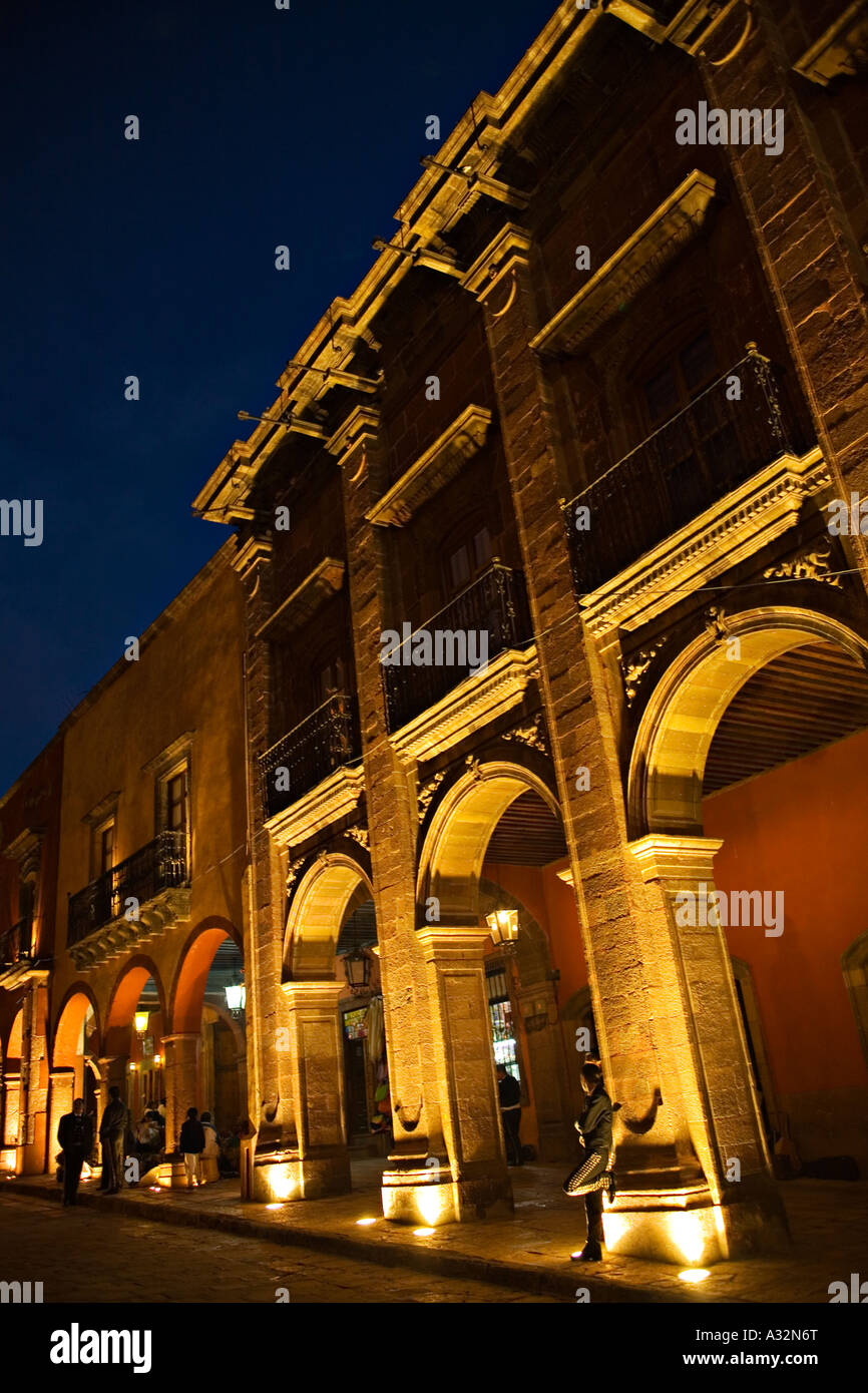 MEXICO San Miguel de Allende Mariachi band members wait in arches of building along el jardin at night Stock Photo